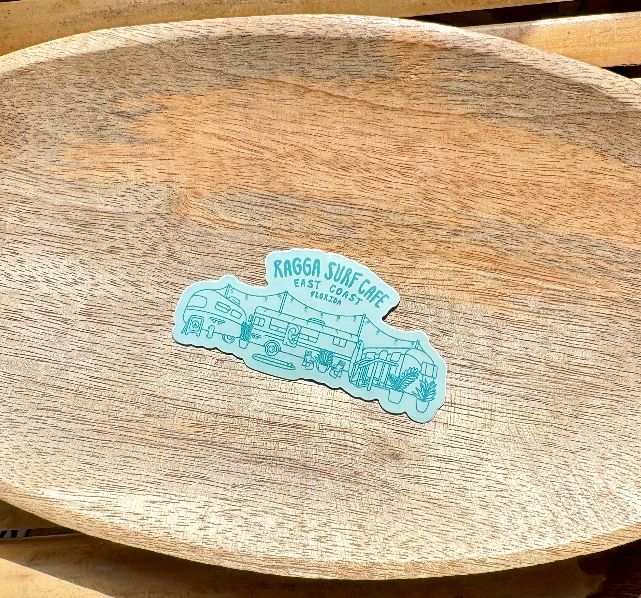 Teal sticker with 'Ragga Surf Cafe'